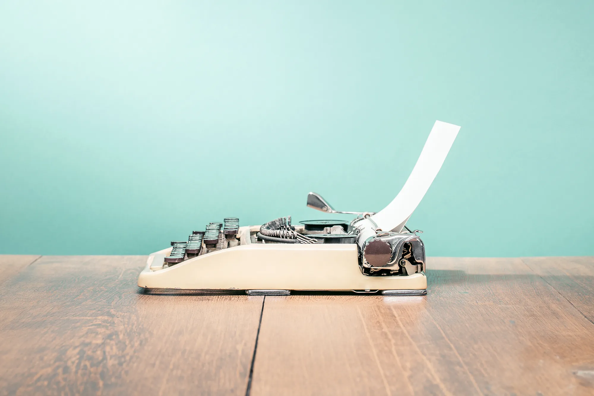 Vintage typewriter on wooden surface.