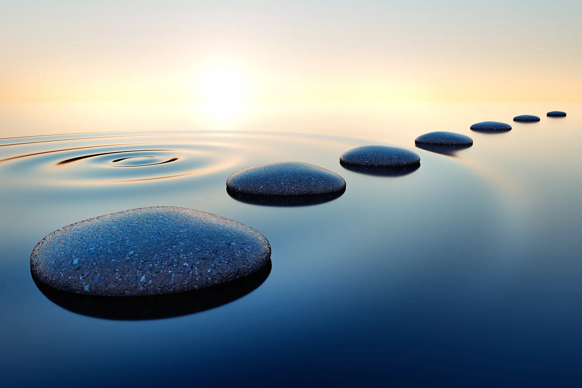 Sunset reflecting off stepping stones in the water, leading to a peaceful destination.