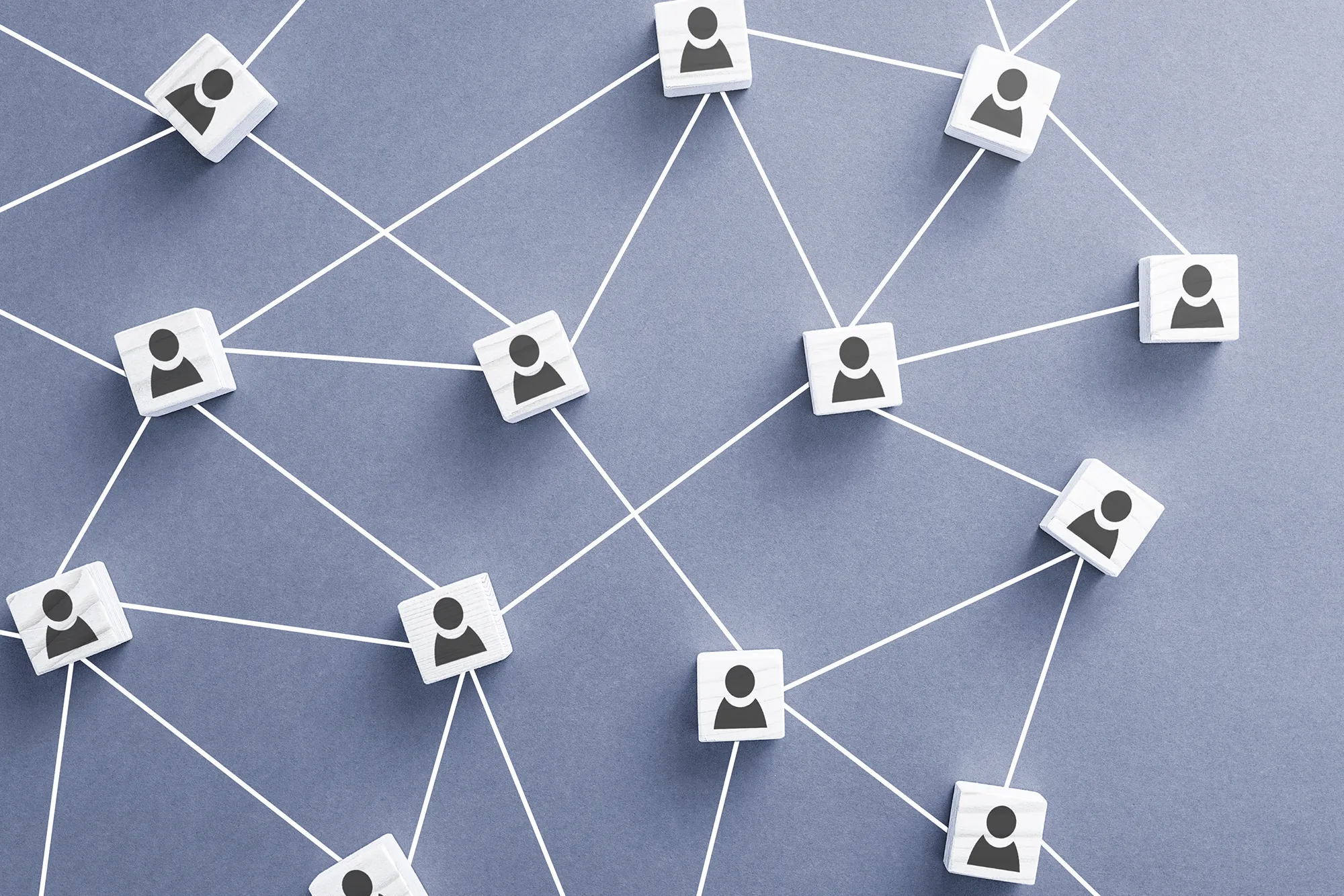 Network diagram of connected person icons linked by lines on a neutral background, representing professional relationships and business networks.