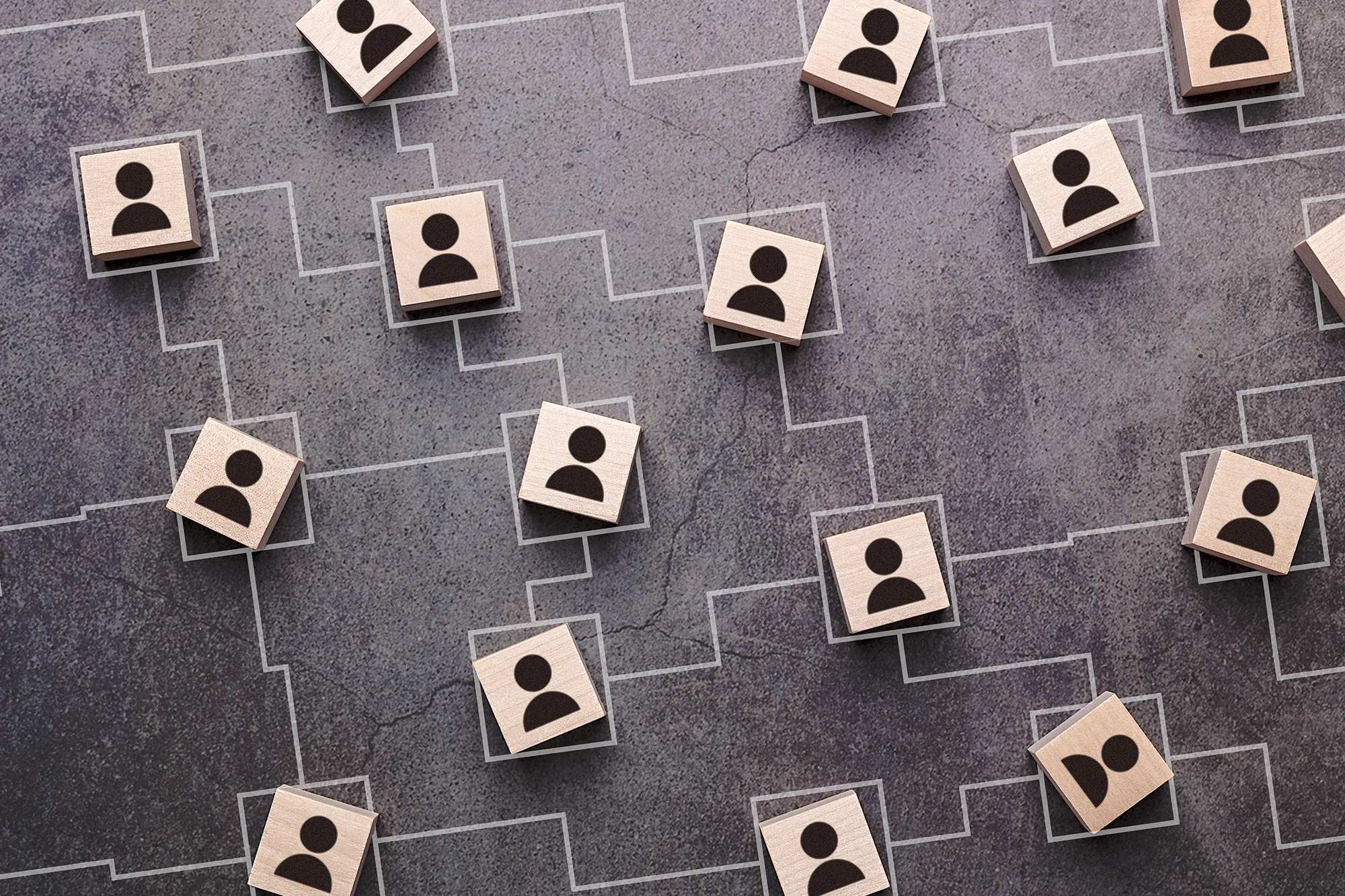 Wooden person icons connected by branching lines to represent a professional network.